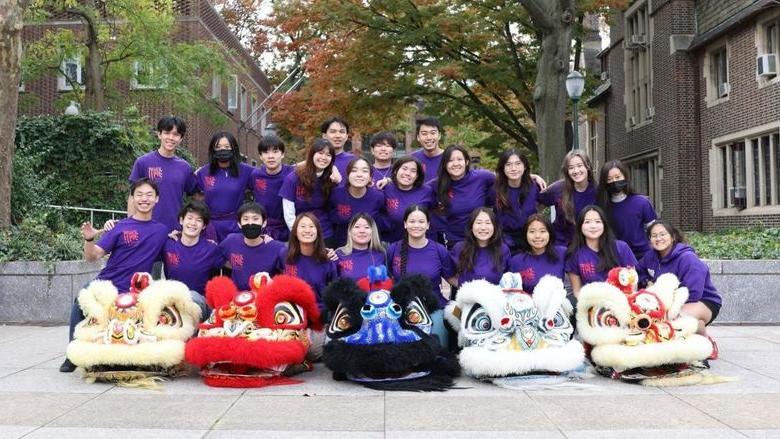 Group of students in purple shirts smiling